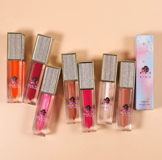 Set of lip glosses with decorative packaging on a beige background